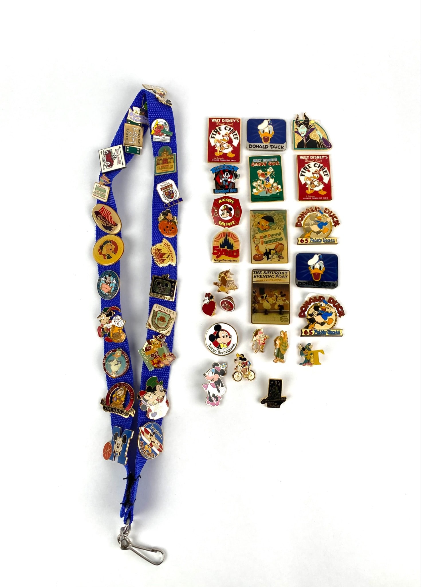 Collection of Disney Enamel Pins with Lanyard and Magnets?: Collection of assorted Disney enamel pins and magnets featuring popular characters such as Mickey, Minnie, Donald Duck, and more. Includes a variety of designs commemorating anniversaries, special edi