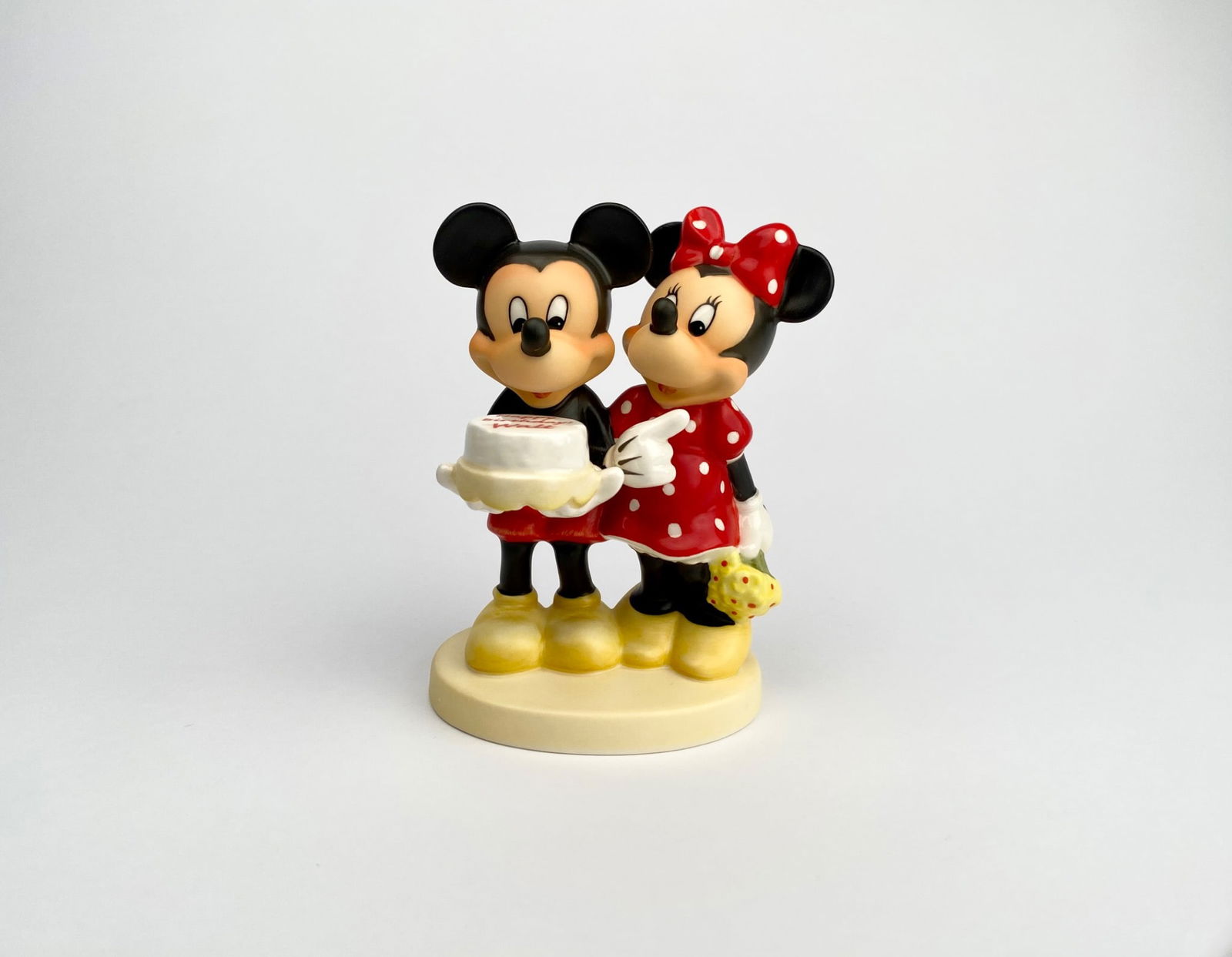 Goebel Mickey and Minnie 100 Years of Disney Hummel Figurine: Goebel Disney ceramic figurine featuring Mickey and Minnie Mouse holding a cake with the inscription Happy Birthday Walt Limited Edition commemorating 100 Years of Walt Disney, produced between Decemb