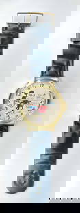 The Disney Channel Collectors Edition Mickey Mouse Large Wall Clock: The Disney Channel Collectors Edition wall clock featuring a large circular metallic gold tone case, a clock face adorned with Mickey Mouse illustrations, and branded inscriptions. The timepiece inclu
