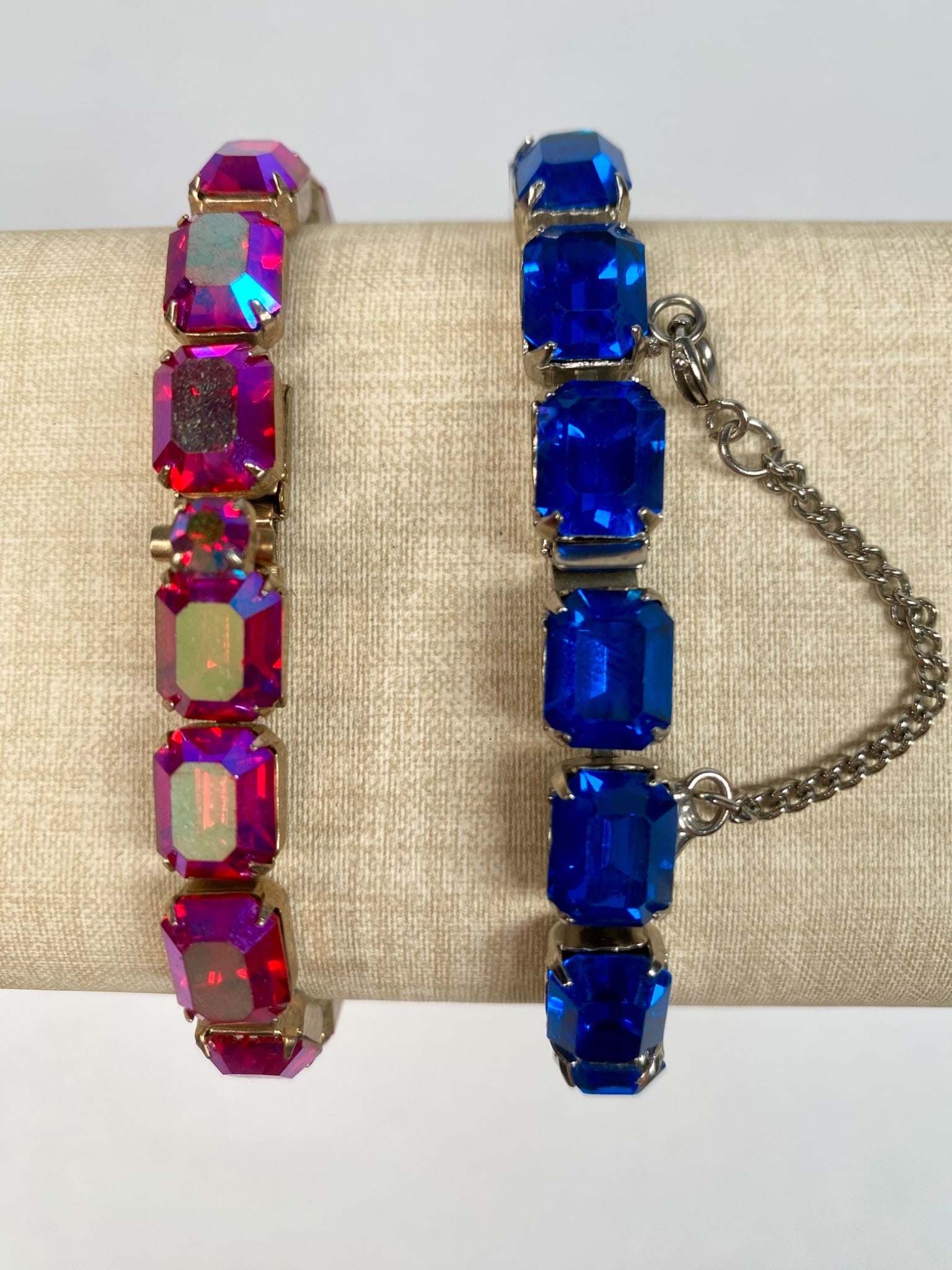 Pair of Weiss and Kramer Rhinestone Link Bracelets in Blue and Pink: Pair of rhinestone bracelets from Weiss and Kramer featuring rectangular cut glass stones in pink and blue. The blue bracelet bears the Weiss stamp on the clasp. The pink bracelet bears the Kramer sta