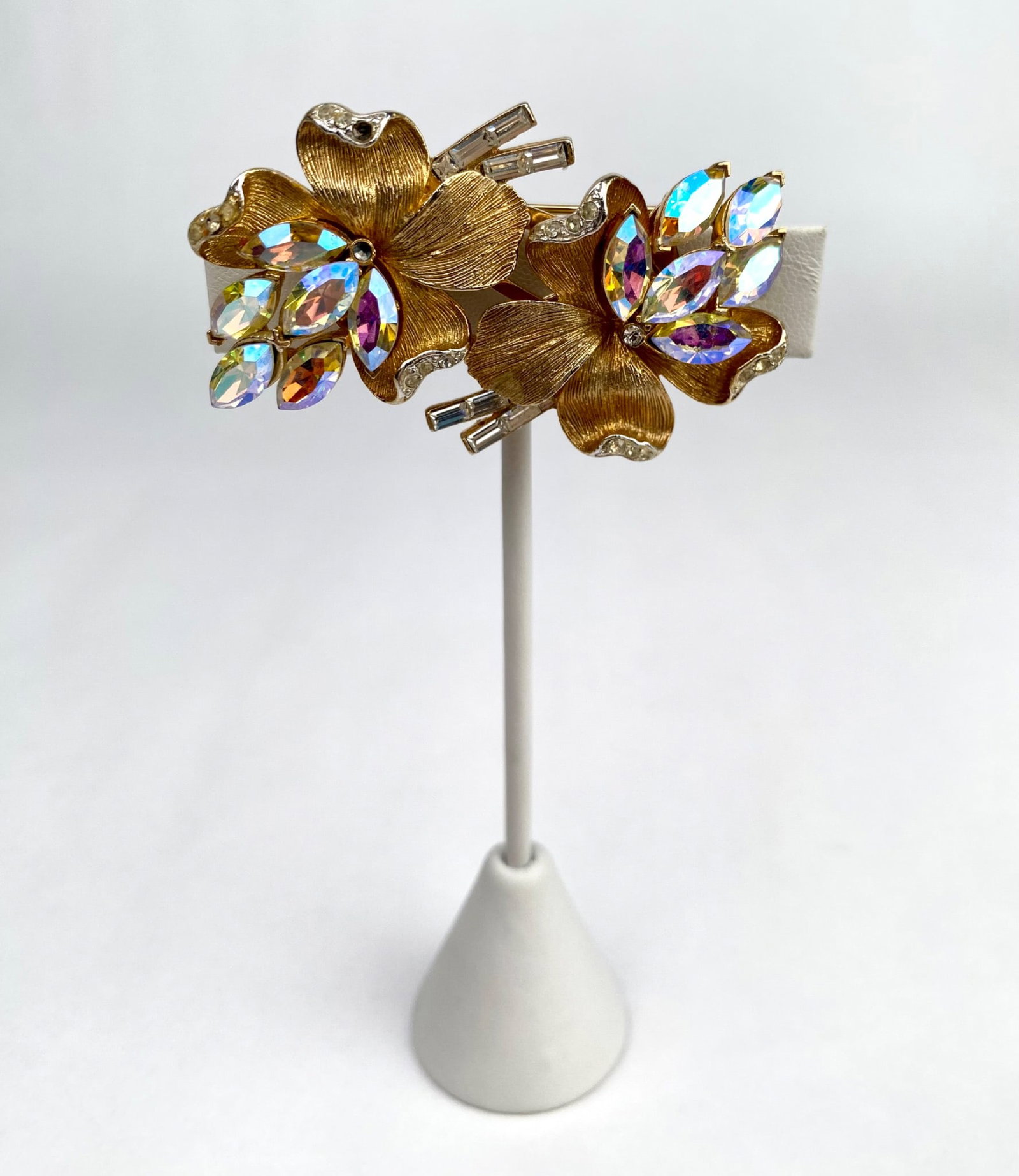 Vendome Aurora Fur Clips and Brooch Set: Vendome gold tone floral brooch and fur clip set, featuring textured detailing and adorned with vibrant Aurora Borealis rhinestones and clear crystal accents. The brooch includes a pin back and secure