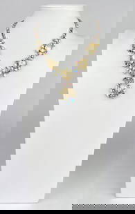 WEISS Necklace Featuring Aurora Borealis Crystals: A Weiss necklace showcasing aurora borealis crystals, faux baroque pearls, and intricate silver tone metalwork. The necklace includes a hook clasp closure and is stamped Weiss on the reverse side. Cla