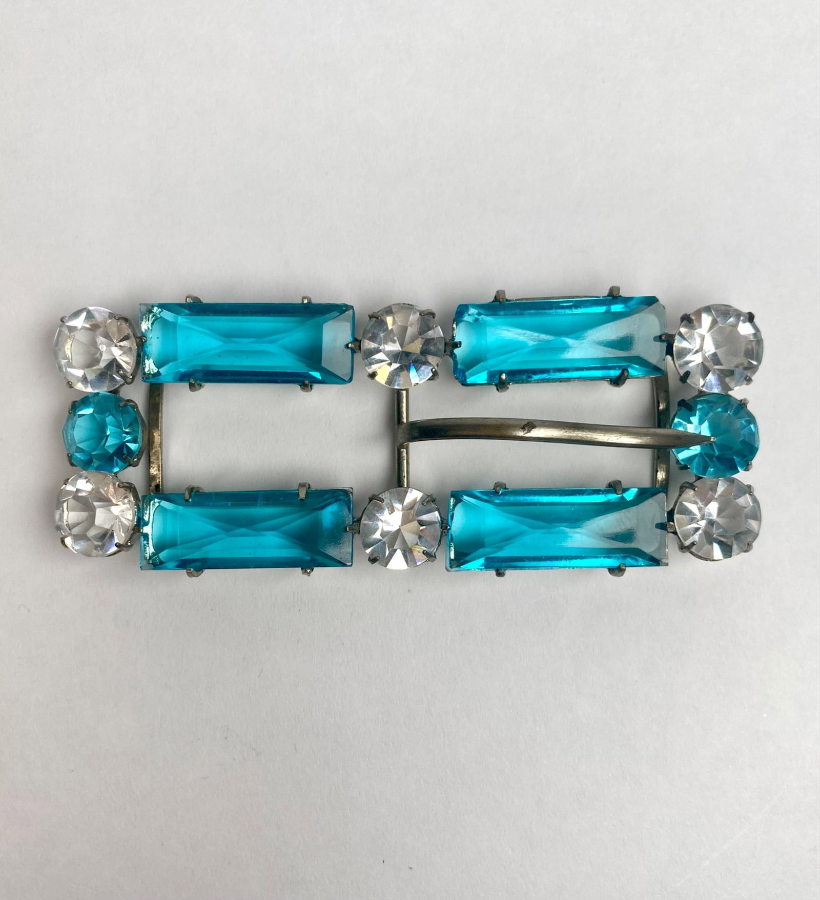 Czechoslovakian Art Deco Blue and Clear Rhinestone Buckle: Rectangular buckle featuring vibrant blue and clear rhinestones set in silver-tone metal. Marked Made in Czechoslovakia, indicative of mid-20th-century craftsmanship. The structure of the buckle inclu