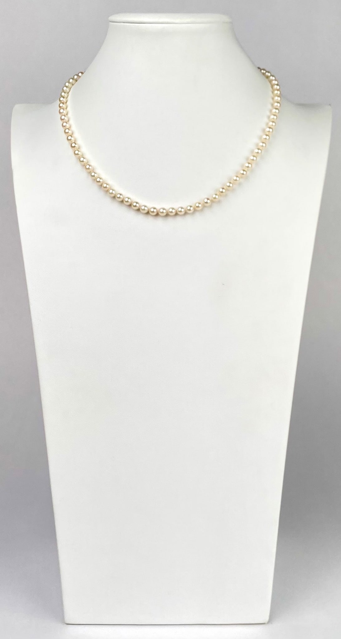 Mid Century 14K Yellow Gold Clasp Cultured Pearl Necklace: A classic pearl necklace featuring cultured pearls, each uniformly sized and strung delicately, secured with a 14K yellow gold clasp. Necklace is in good condition. Please see photos for additional de