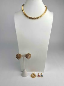 Signed Nolan Miller jewelry set featuring gold tone necklace, matching clip on earrings, and three