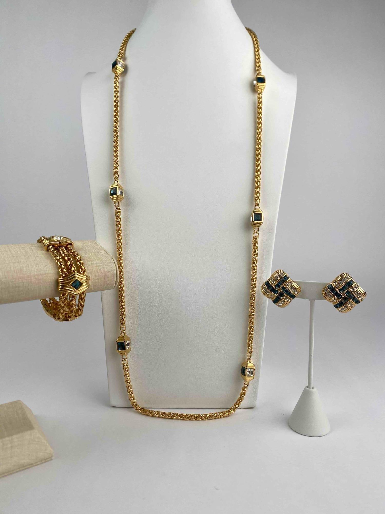 This is a signed Nolan Miller jewelry set featuring a long gold-tone rope chain necklace with (1 of 12)