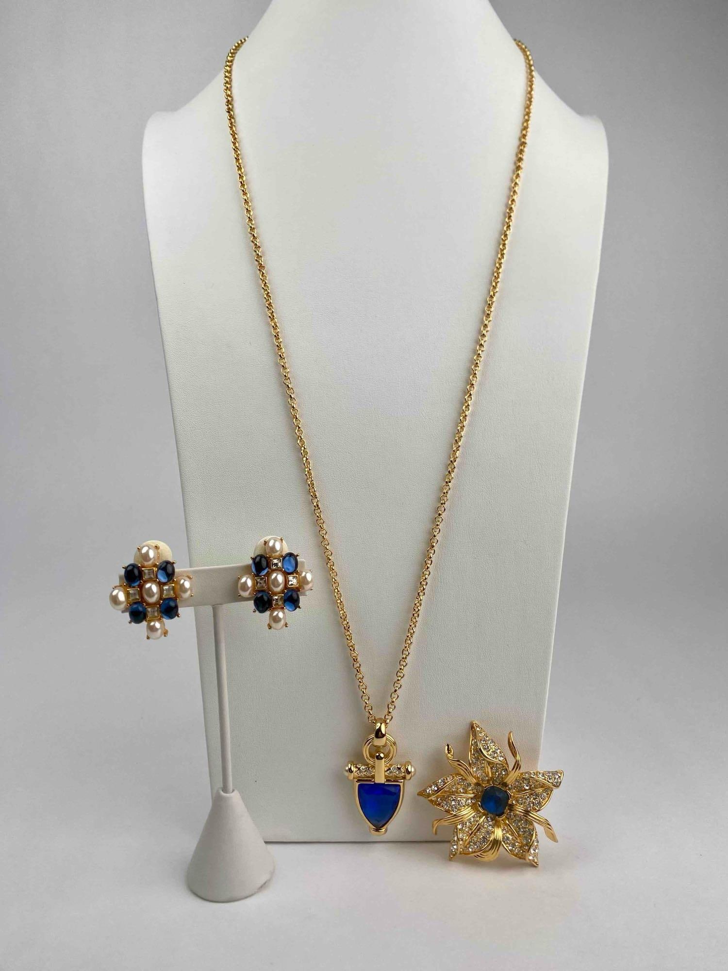 Lot of signed Nolan Miller jewelry featuring rich blue and pearl accents. The lot includes a (1 of 12)