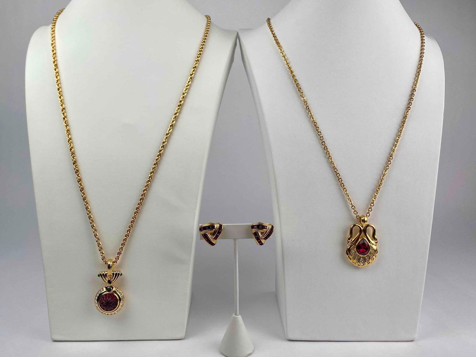 Lot of three signed Nolan Miller jewelry pieces featuring rich red crystals in gold tone settings. (1 of 12)