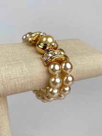 Signed Kenneth Jay Lane (KJL) bracelet featuring two strands of faux pearls joined by a striking