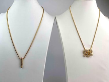 Pair of signed KJL necklaces, each featuring a distinctive pendant. One showcases a pave crystal