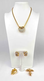 Four piece Nolan Miller costume jewelry set featuring a necklace with a shell pendant, a pair of