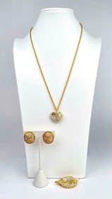 Assorted lot of three jewelry pieces from Nolan Miller. Lot includes a necklace, brooch and a pair