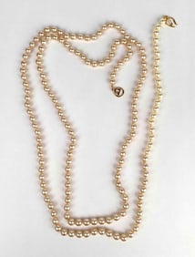 Faux pearl necklace by Kenneth Jay Lane. Necklace has a gold tone broken clasp as pictured. Clasp is