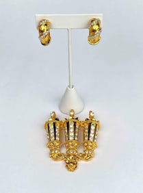 Large gold tone brooch and a pair of clip on earrings by Kenneth Jay Lane. Brooch is a gold tone