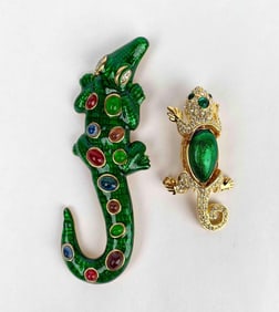 Pair of gold tone crocodile brooches by Kenneth Jay Lane. One brooch has green enamel with multi