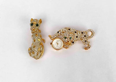 Set of gold tone cat brooches by Kenneth Jay Lane. Both brooches are adorned with rhinestones and