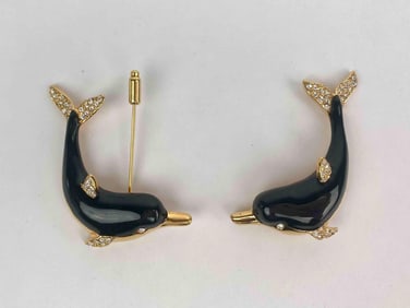 Pair of signed KJL (Kenneth Jay Lane) dolphin brooches featuring glossy black enamel bodies and