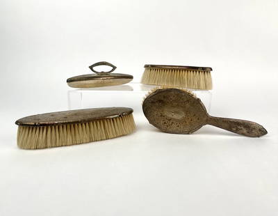 Antique Sterling Silver Vanity Brush Set: Four piece antique sterling silver vanity brush set featuring a classic floral repousse pattern. Set includes a handled hairbrush, two clothing brushes of differing lengths, and a hand held crumb