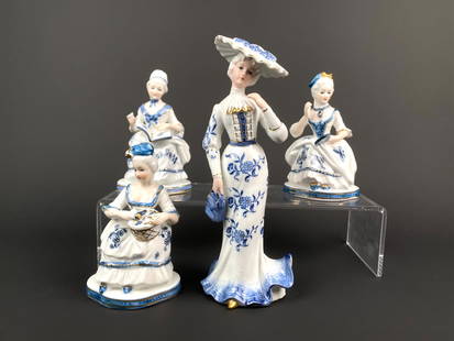 Set of Four KPM Blue and White Porcelain Figurines: Set of four elegant KPM porcelain figurines, each showcasing a finely dressed lady in blue and white palette with gold accents. The tallest figurine, dressed in Edwardian style attire, features a