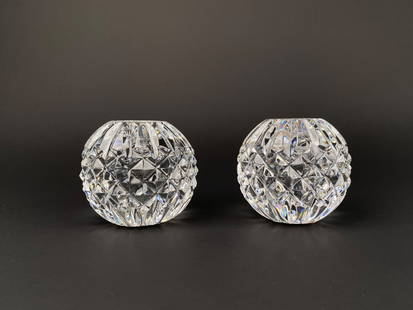 Pair of Waterford Crystal Cut Glass Votive Candle Holders: Pair of Waterford Crystal votive candle holders in clear cut glass. Each holder features a rounded form with a deep diamond and vertical fluted cut pattern. Designed to hold votive or tealight candles