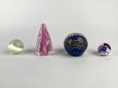 Group of Four Contemporary Art Glass Paperweights and Sculptures: Group of four colorful contemporary art glass pieces. Included is a cobalt blue and gold swirling orb wrapped in a delicate silver wire, signed and dated on the base, a tall teardrop form pink and cle