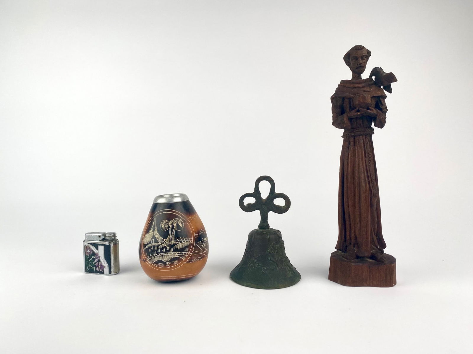 Group of Decorative Collectibles Including Carved Wood Saint Figure, Bronze Bell, Cordoba Gourd, and (1 of 12)