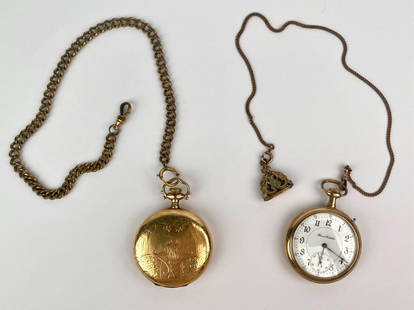 Pair of Antique Gold Tone Pocket Watches with Chains: Pair of antique gold tone mechanical pocket watches with attached chains and fobs. The first watch, signed Illinois Watch Co., features a clean white enamel dial with bold numerals and blued hands, ac