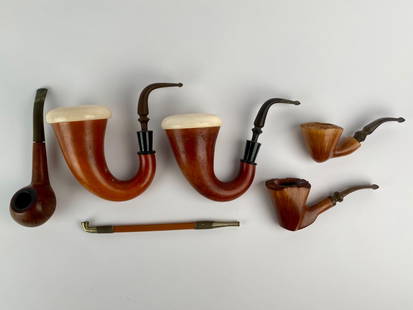 Group of Six Vintage Tobacco Pipes Including Tim West and Charatan's Make: Group of six vintage tobacco pipes, including both artisan and factory made pieces. The lot features two large bent pipes with smooth bowls and white meerschaum tops. Also included are two carved plat