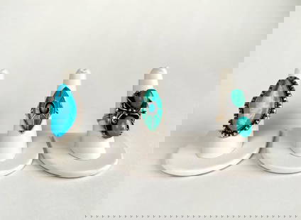 Three Sterling Silver and Turquoise Rings: Three sterling silver rings featuring turquoise stones. One showcases a marquise shaped turquoise with an etched sterling border. The second, marked AB, displays two cabochon turquoise stones with