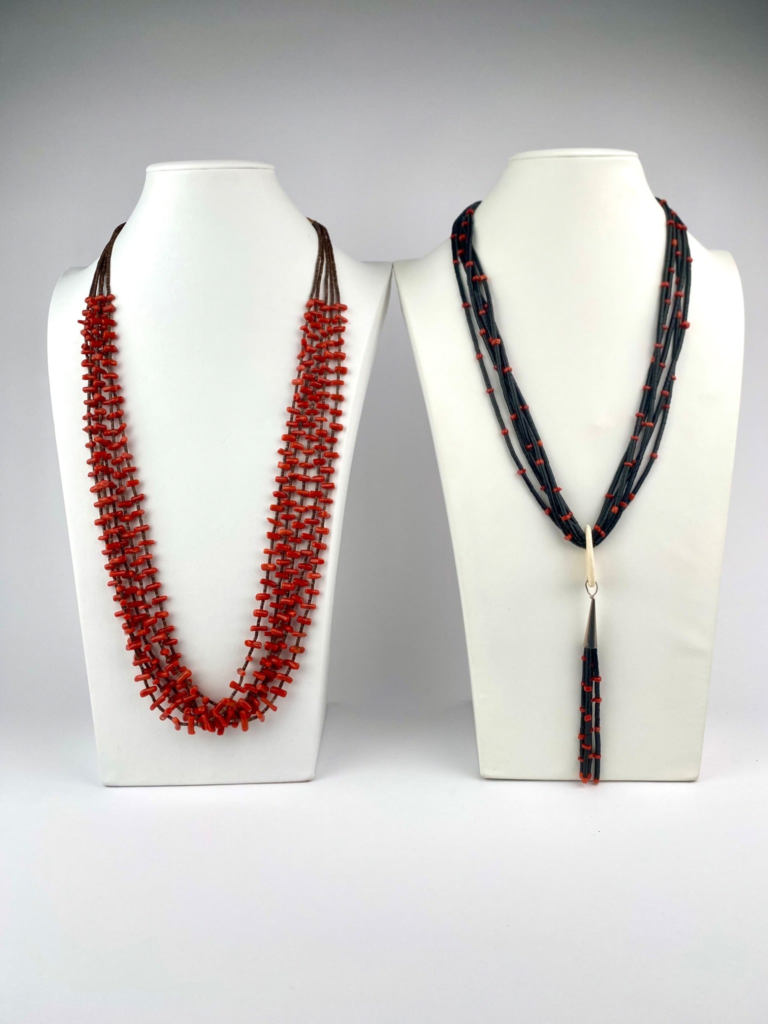 Pair of Multi-Strand Native American Style Beaded Necklaces featuring Coral and Heishi: Pair of multi-strand beaded necklaces inspired by Native American jewelry. The first necklace features red branch coral beads interspersed with brown shell heishi beads, strung in five twisted strands