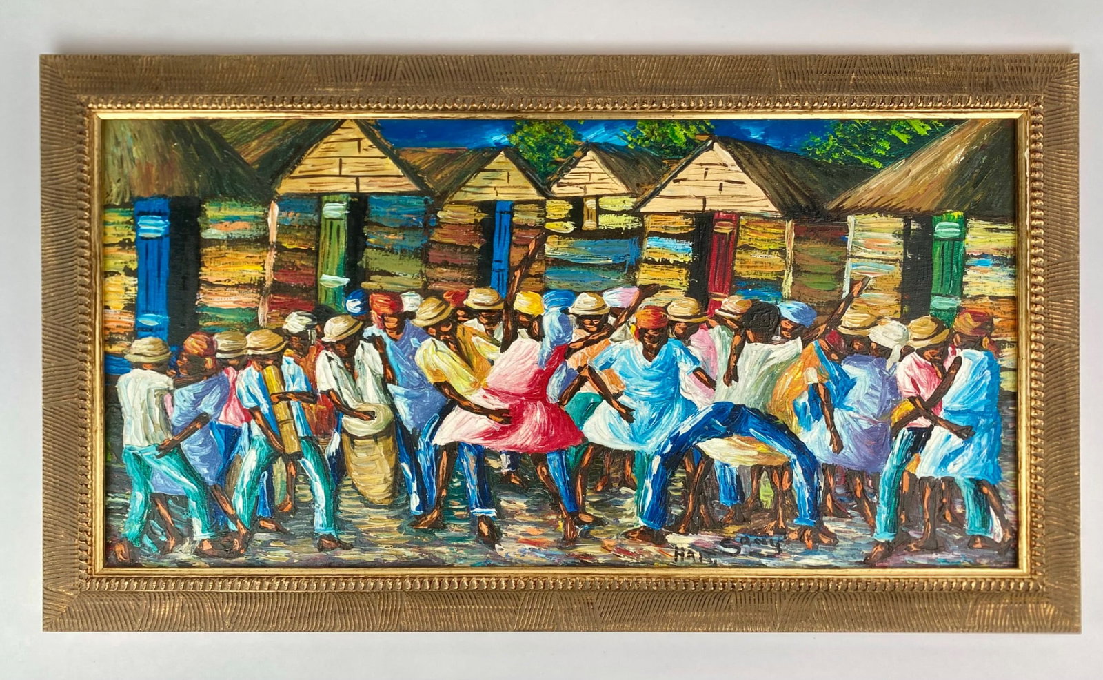 Signed Haitian Village Celebration Oil Painting: Vibrant Haitian oil painting on canvas depicting a lively village celebration with musicians and dancers in front of brightly painted huts. The piece features rich brushwork and dynamic composition. T