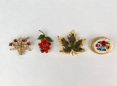 Four Decorative Gold Tone Brooches Featuring Floral and Leaf Motifs