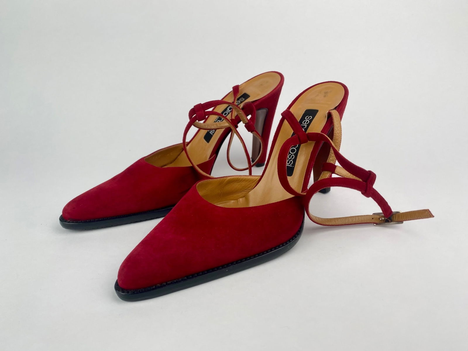 Sergio Rossi Red Suede Strappy Slingback Heels (Size 40.5): Pair of red suede slingback heels by Sergio Rossi. Featuring a pointed toe and a sculpted high heel, the design includes delicate suede and leather crossover straps with a side buckle closure. The ins