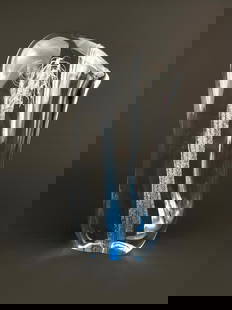 Signed Studio Art Glass Vase with Blue and White Interior Design: A clear studio art glass vase with an organic, asymmetrical form and a pulled spout. The interior features blue and white cane trails and controlled bubbles, suspended vertically through the body is i