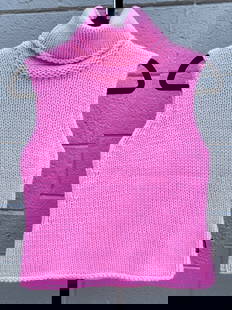 Versace Jeans Couture Pink Knit Sleeveless Turtleneck Top: Versace Jeans Couture sleeveless turtleneck sweater in bright bubblegum pink. The top features a thick ribbed knit design, a rolled-edge turtleneck collar, and subtle shaping at the sides. Constructed