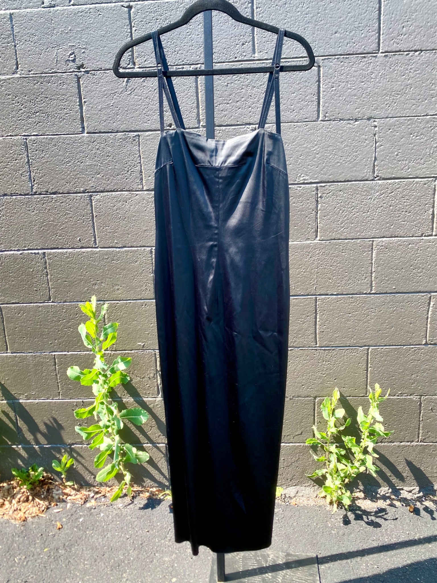 Dolce & Gabbana Black Satin Bodycon Dress, Size 44: Black slip-style dress by Dolce and Gabbana, made in Italy and tagged size 44. Crafted from a high-sheen stretch satin blend, the dress features a structured bodycon silhouette with darted bust, adjus