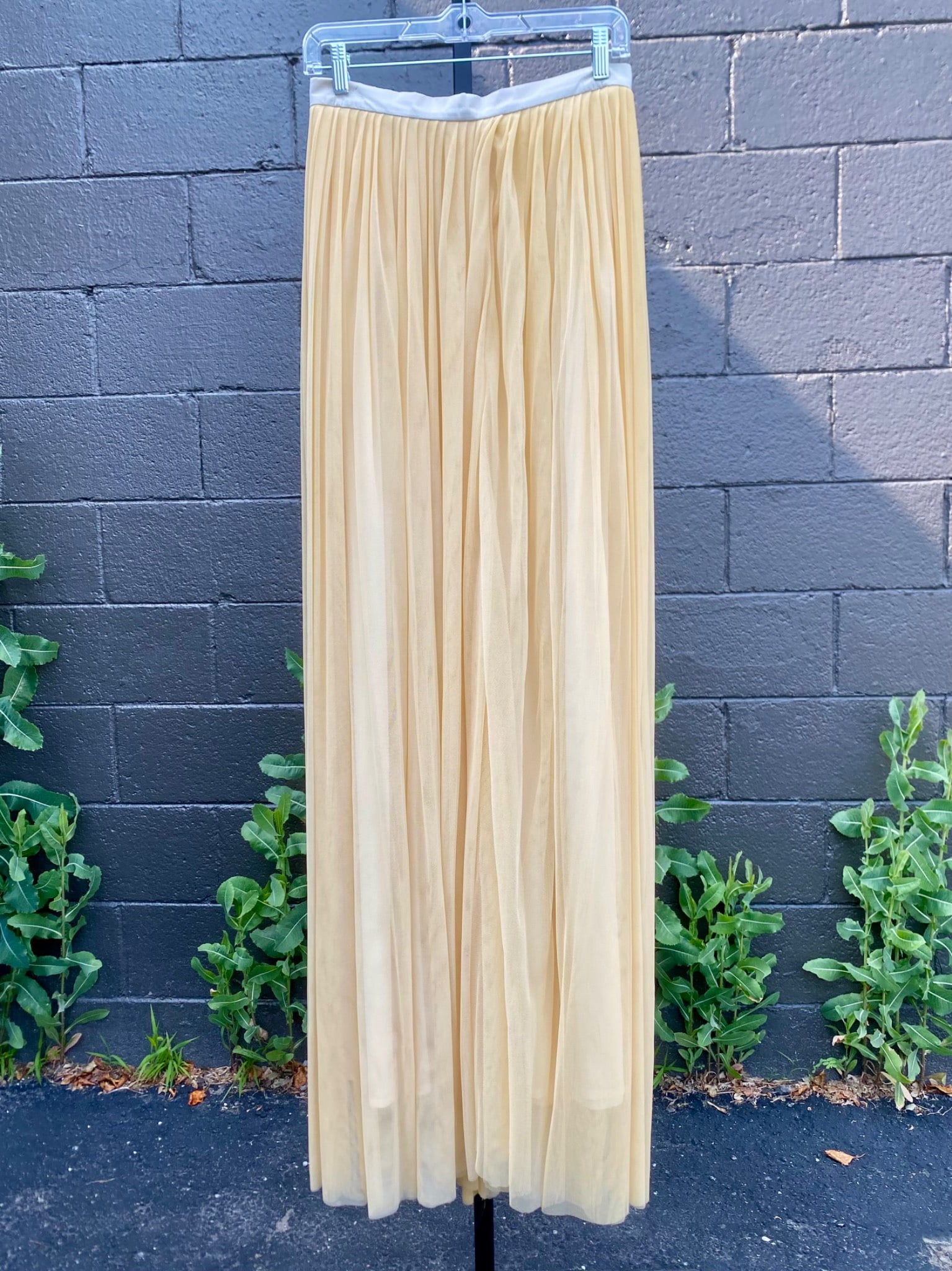 Mondi Pleated Champagne Tulle Maxi Skirt, Size 38: Mondi pleated champagne colored maxi skirt featuring an airy tulle overlay and a silky full lining. The skirt is detailed with a soft satin waistband in a complementary shade and a rear button and zip