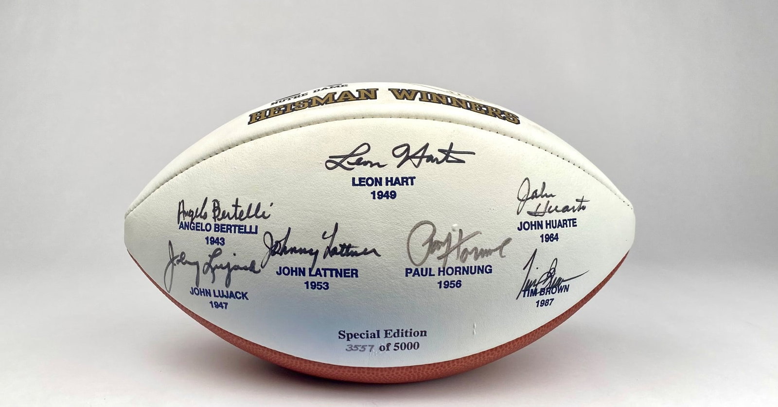 Notre Dame Special Edition Football Signed by Heisman Winners: Notre Dame-themed special edition football featuring printed signatures of Heisman Trophy winners. The ball includes notable winners such as Leon Hart (1949), Paul Hornung (1956), Johnny Lattner (1953