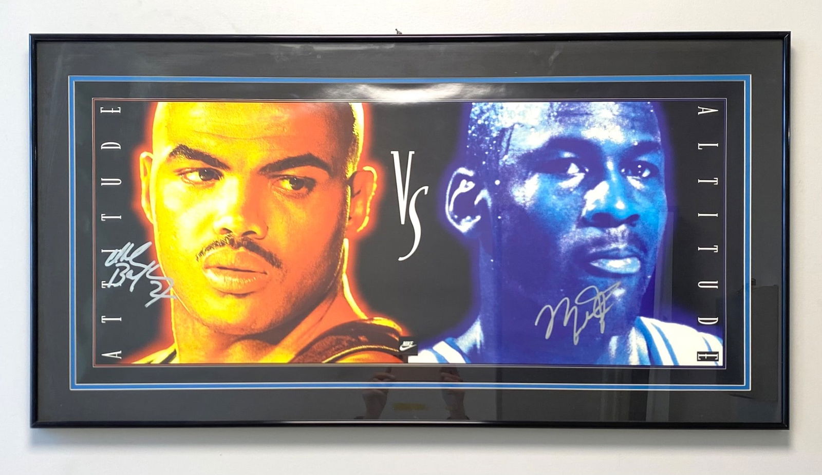 Charles Barkley and Michael Jordan Signed "Attitude vs. Altitude" Nike Poster: Framed and matted sports poster featuring a dual-image and bold color depiction, signed by Charles Barkley in silver ink and an Michael Jordan's autograph in gold ink. The artwork prominently displays