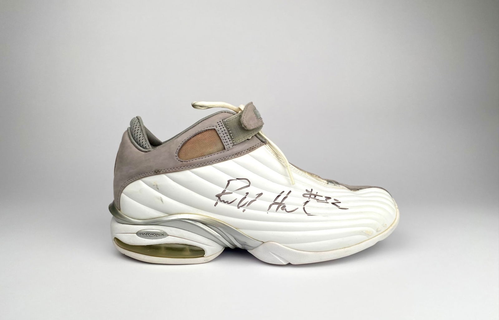 Signed Richard Hamilton And1 Ryd 1 Basketball Shoe (#32) Size 13: Single athletic shoe signed by Richard Hamilton. Features a white and beige design with visible air cushioning and mesh lining. The shoe shows wear consistent with age and use, including marks and scu