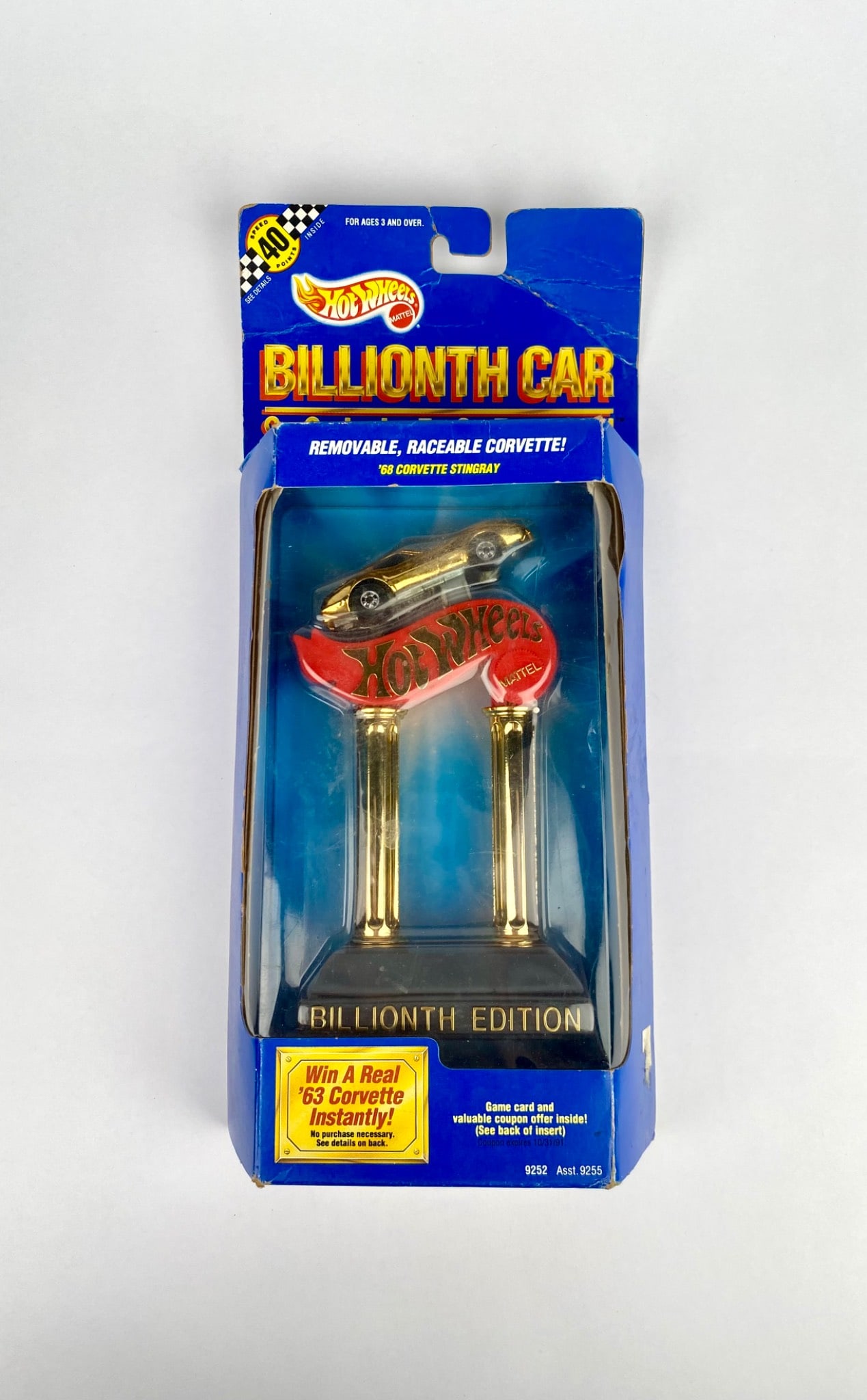 Hot Wheels Billionth Edition '68 Corvette Stingray in Original Packaging: Hot Wheels Billionth Car Collection featuring a '68 Corvette Stingray in gold finish. The collectible is presented in its original unopened packaging, complete with promotional details. The box exhibi