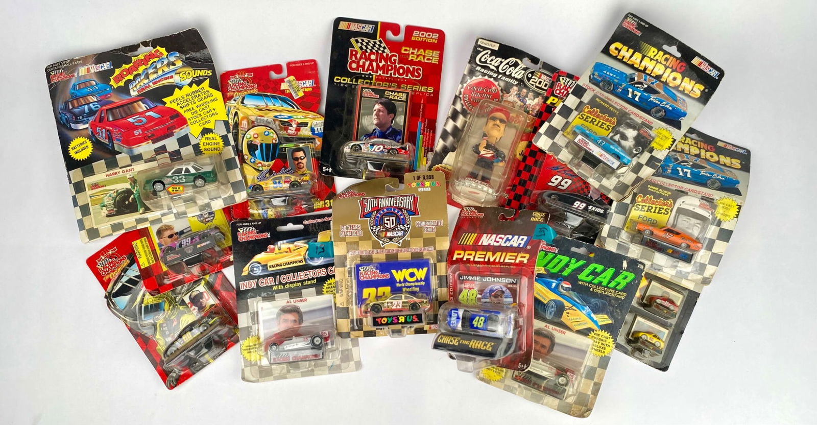 NASCAR Die-Cast Cars and Collectibles Lot in Original Packaging: NASCAR-themed die-cast cars and collectibles, including various Racing Champions, Indy Car, NASCAR Premier, and Coca-Cola Racing Family series. Items come with original packaging, showing some signs o