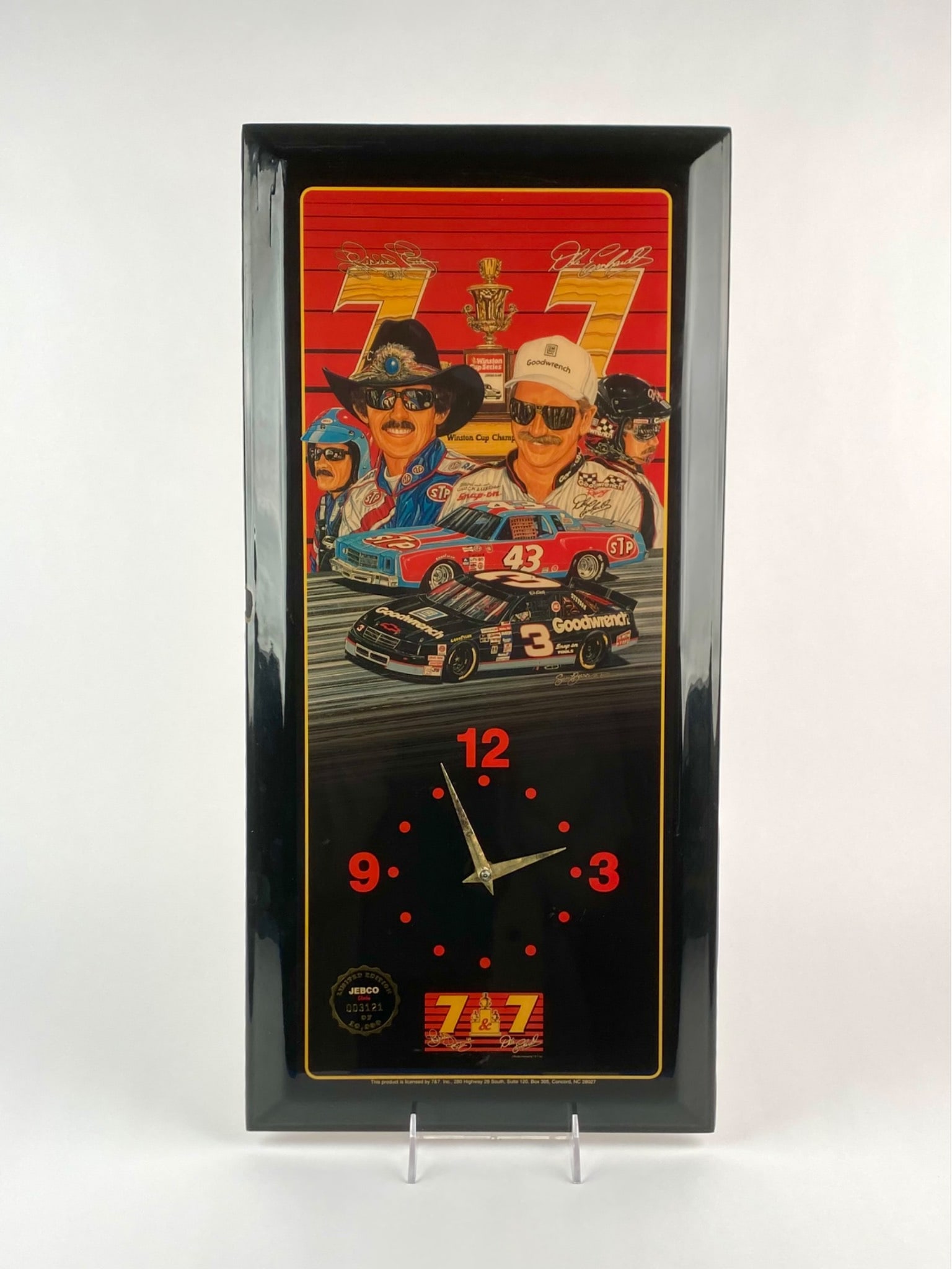 Limited Edition Jebco NASCAR Clock Featuring Richard Petty and Dale Earnhardt: Limited edition Jebco wall clock commemorating NASCAR legends Richard Petty and Dale Earnhardt. The design features portraits of both drivers, their cars, and Winston Cup trophy artwork again a red ba