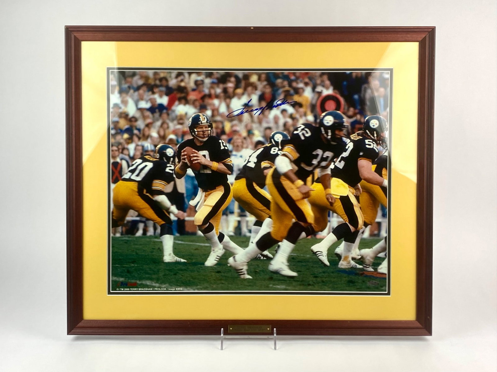 Pro Look Terry Bradshaw Signed Pittsburgh Steelers "Super Bowl XIII MVP": Framed photograph signed by Hall of Fame quarterback Terry Bradshaw, featuring him in action with the Pittsburgh Steelers during their Super Bowl XIII victory. The autograph, executed in blue marker, 