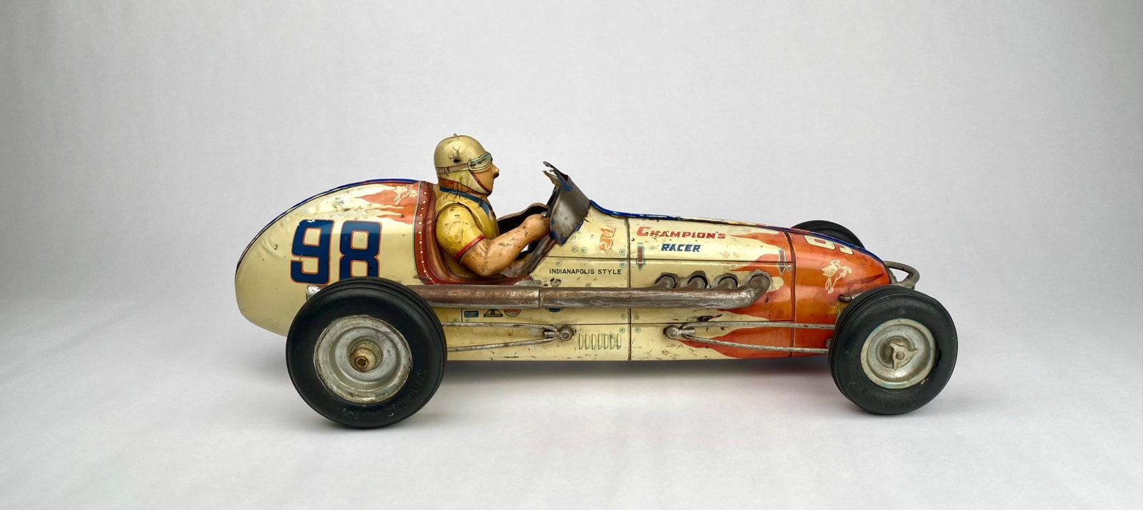 Vintage Japanese Tin Champion's Racer #98, Troy Ruttman: Tinplate Champion's Racer No. 98, Troy Ruttman, featuring detailed driver and racecar graphics. Marked "Made in Japan" with additional sponsor decals. Includes a driver figure in a helmet with a steer