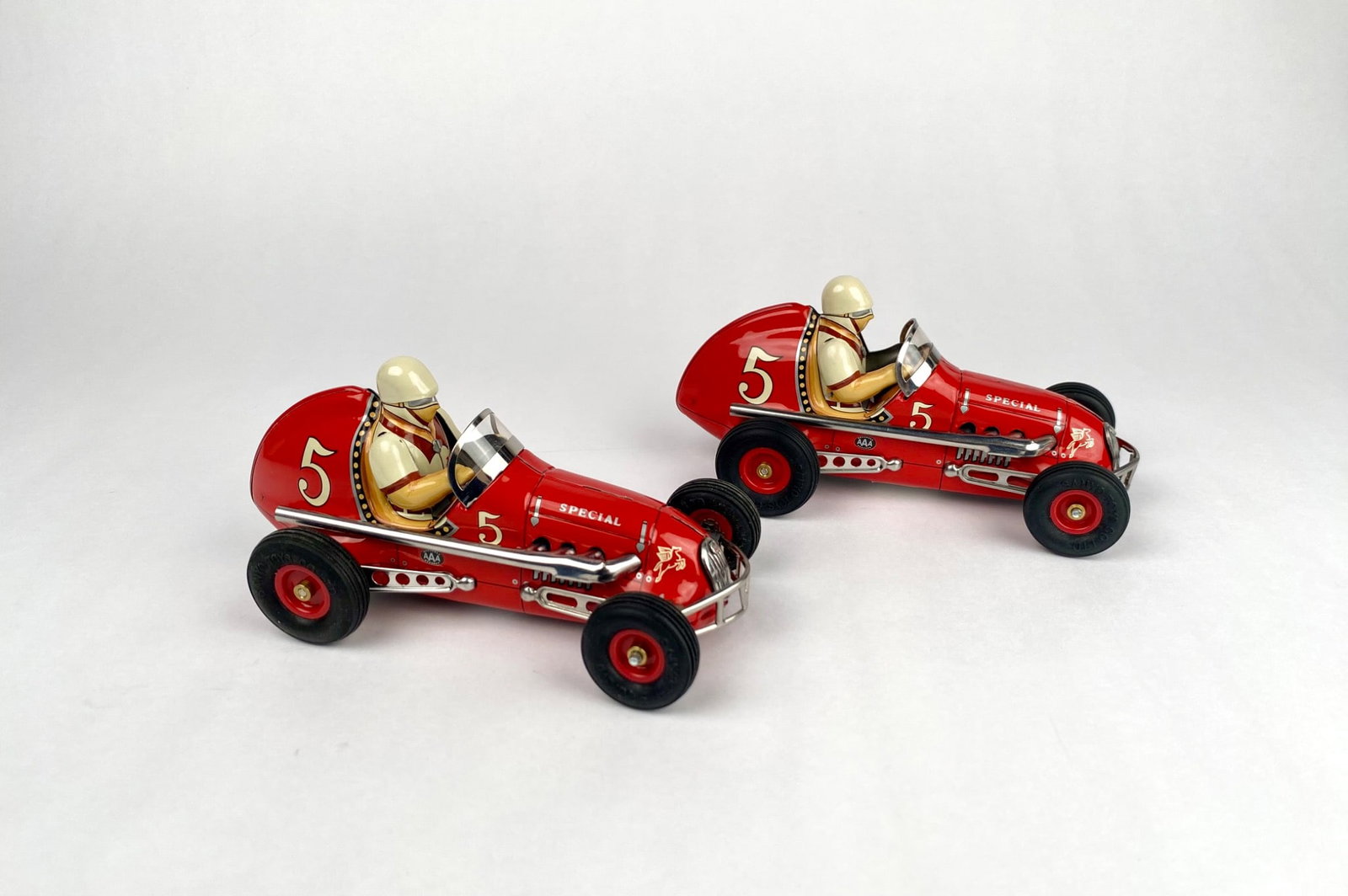 Pair of Vintage Japanese Tin Litho "Special #5" Race Cars with one original box: Tinplate race cars marked ˜Sanyo Toys Co., Ltd., Made in Japan." Both cars feature a bright red color, the number 5 on the sides and rear, and "Special" decals on the hood. Includes detailed molded d