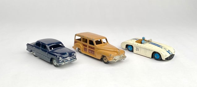 Three Dinky Toys Diecast Cars Including Ford Sedan, Station Wagon, and Cunningham C-5R