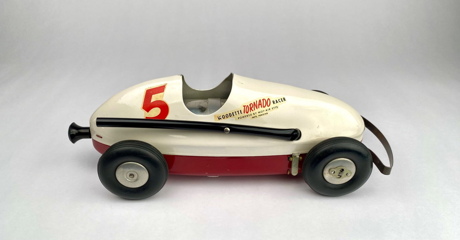 Woodette Tornado Racer by Winzeler Mfg. & Tool Co., Chicago, USA: White and red Woodette Tornado Racer powered by Mot-Air Ette. Manufactured by Winzeler Mfg. & Tool Co., Chicago, USA, for Woodettes, Inc. Features include "5" decals on the sides and hood, rubber whee