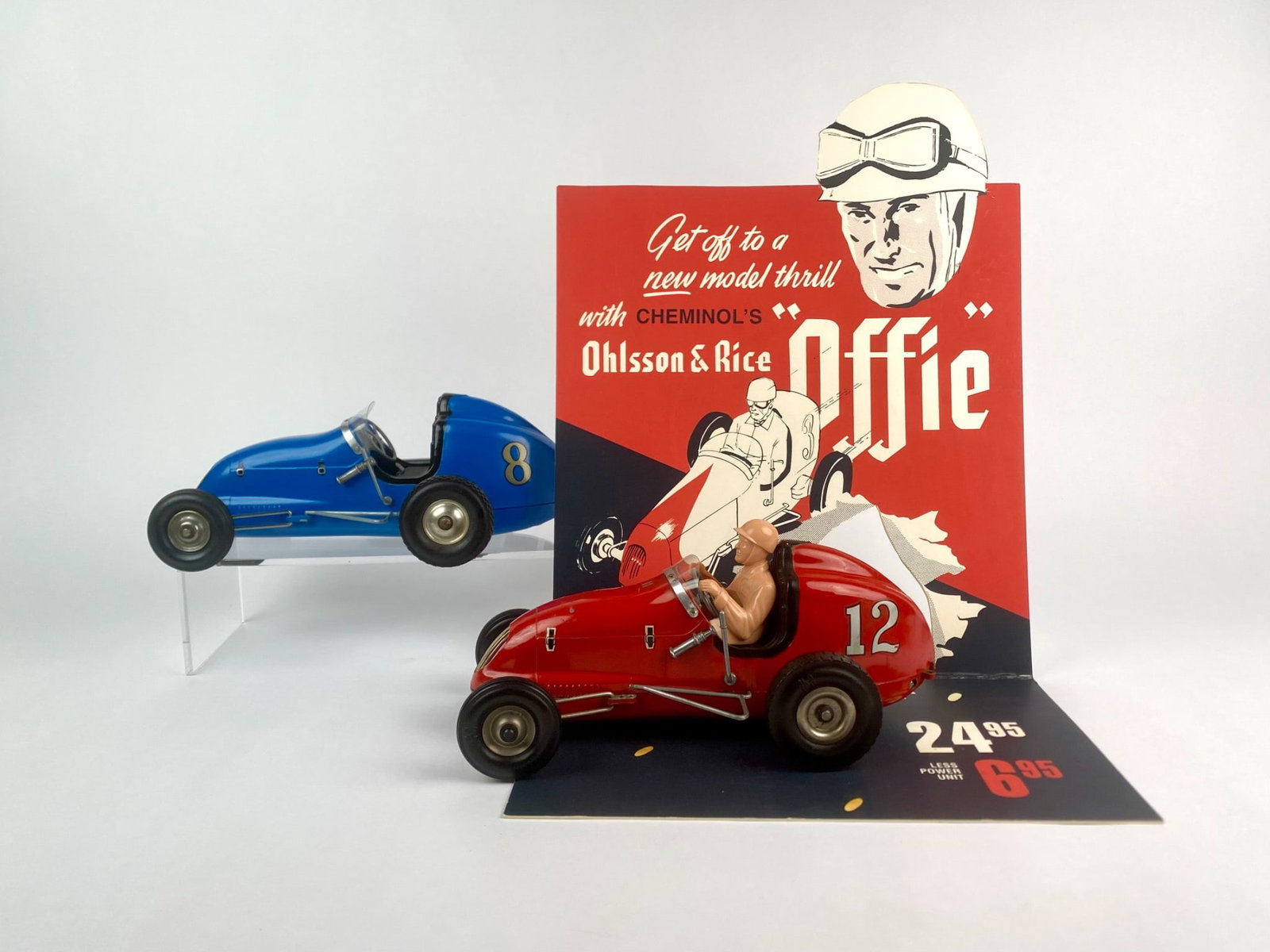 Ohlsson & Rice 'Offie' Tether Car Pair with Advertising Display: Set of two vintage Ohlsson & Rice "Offie" tether race cars, including a red #12 with driver figure and a blue #8 without driver. Both cars feature metal bodies, rubber tires, and detailed trim, with u