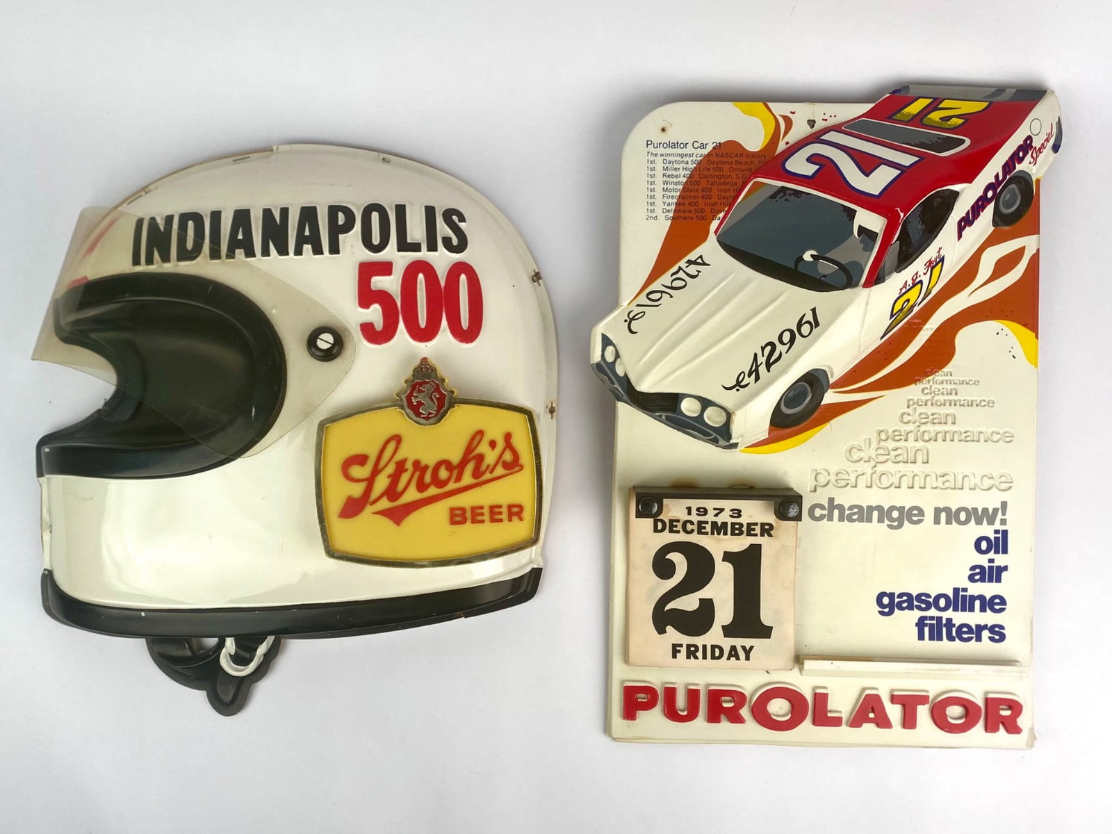 Vintage Indianapolis 500 Stroh's Beer Helmet Sign & 1973 Purolator Racing Calendar Display: Set includes two vintage racing-themed advertising displays. The first is a Stroh's Beer Indianapolis 500 helmet-shaped sign, produced by the Stroh Brewery Company, Detroit, Michigan. The second piece